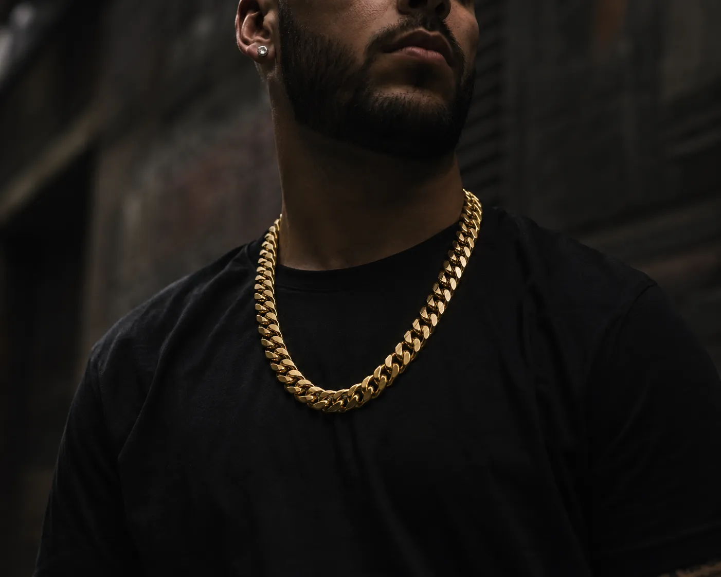 Man wearing a 14K yellow gold Cuban link chain by Nuralet